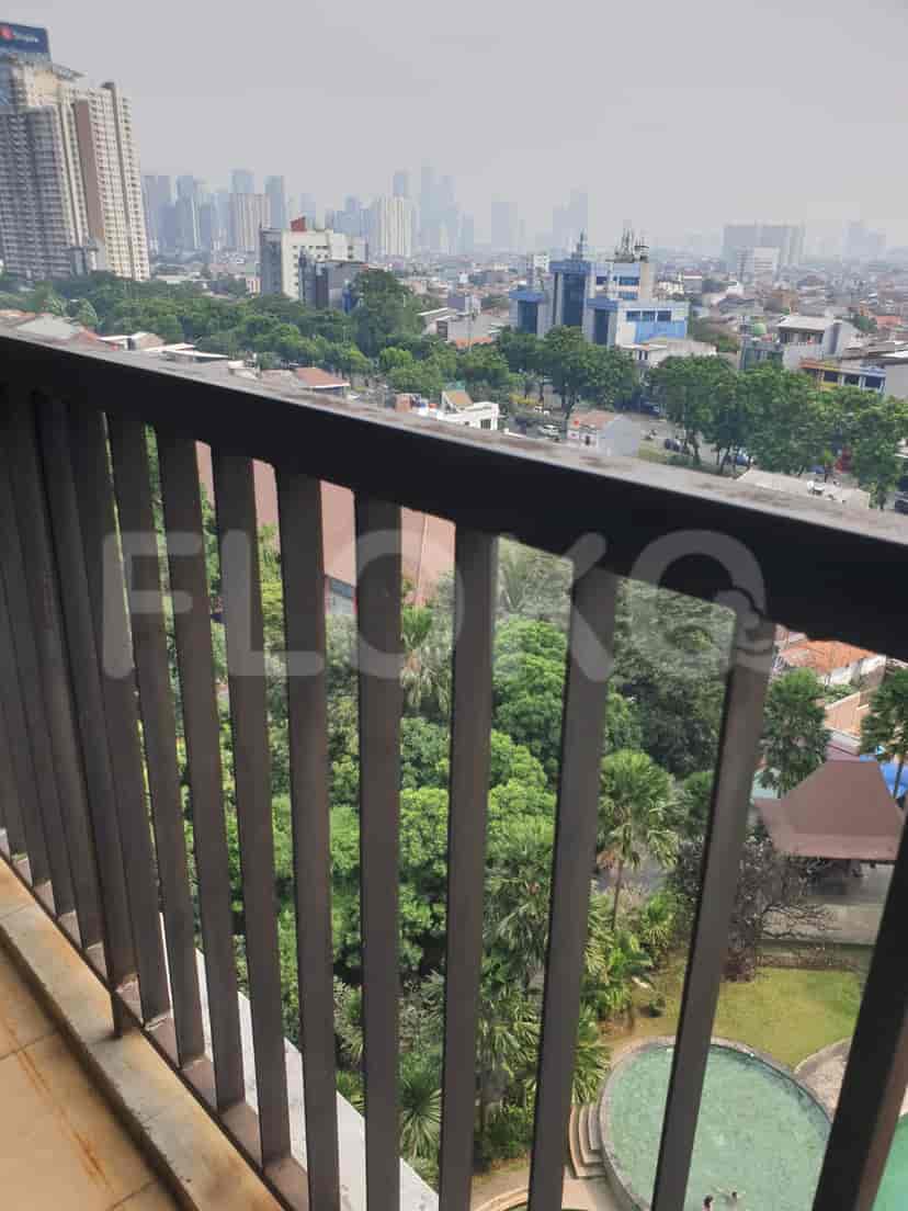 Balcony with a metal railing overlooking a city view.