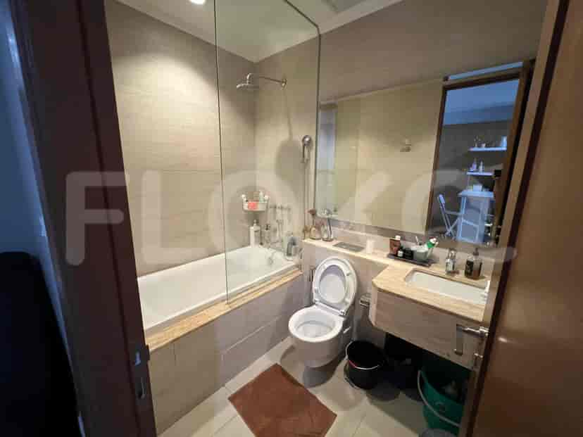 Modern bathroom with a bathtub, glass shower screen, and sink.