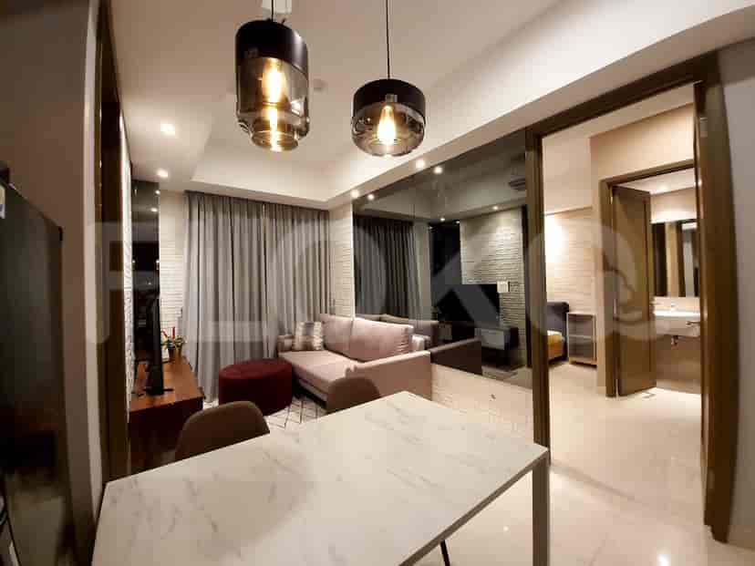 Modern living space with dining area. Features include a pink sofa, a marble dining table, and pendant lighting.