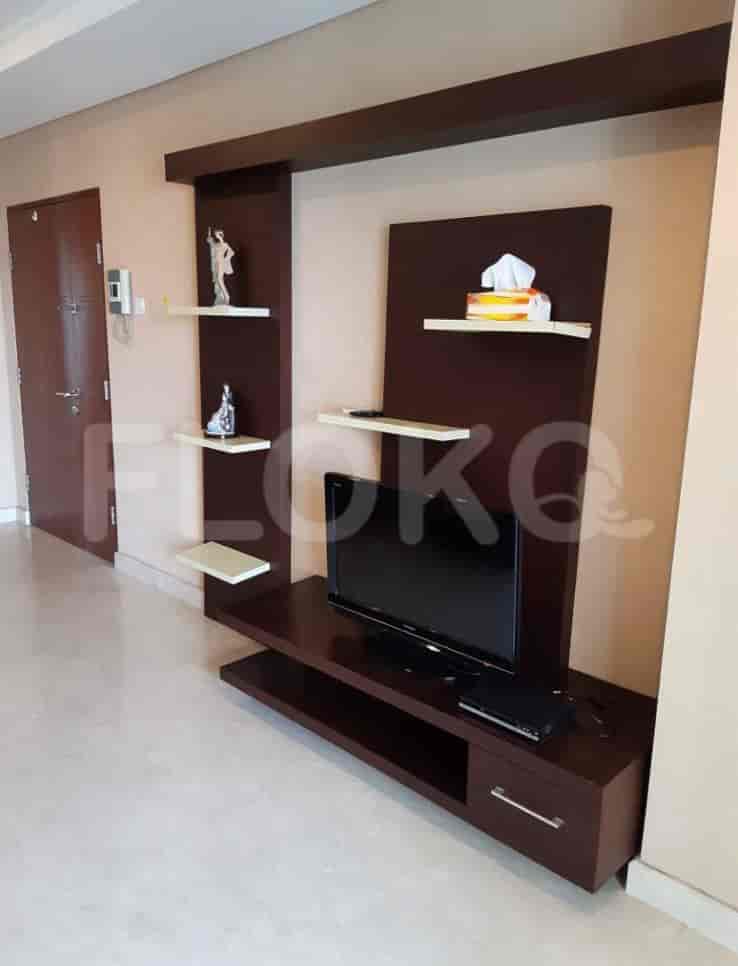 Living room with a TV unit and shelving.