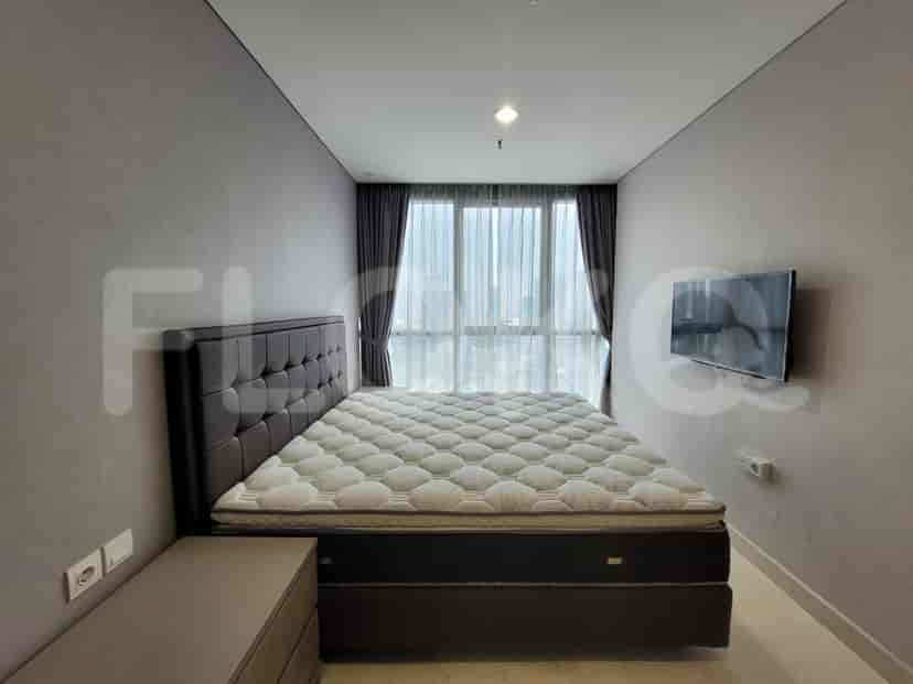 A bedroom with a bed and a smart TV.