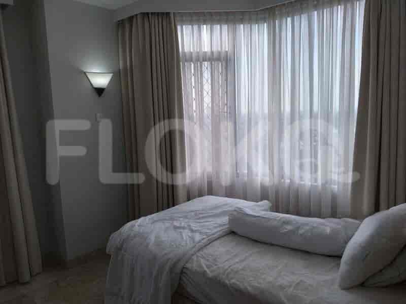 A bedroom with a bed and curtains.