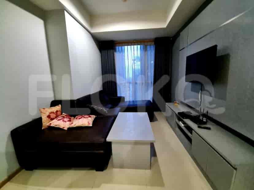 Living room with grey sofa, coffee table, and smart TV.