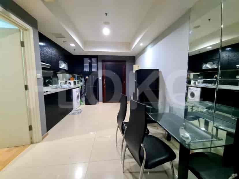 View of the kitchen and dining area, showing the dining table and appliances.