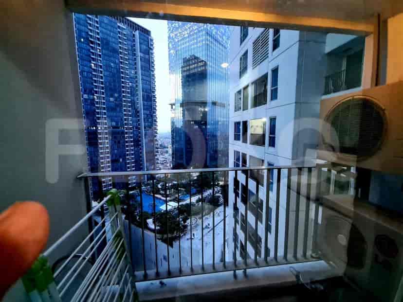 View from balcony with city skyline, buildings, and air conditioning.