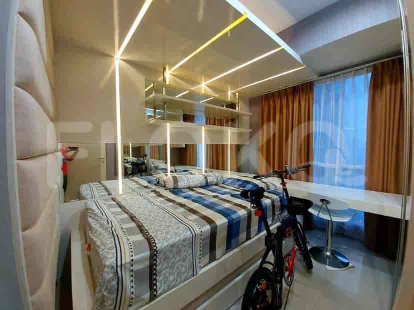 Bedroom featuring a bed, a white desk, and a bicycle.