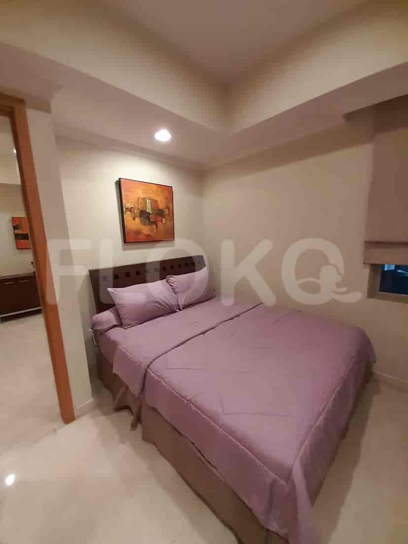 Bedroom with bed and artwork.