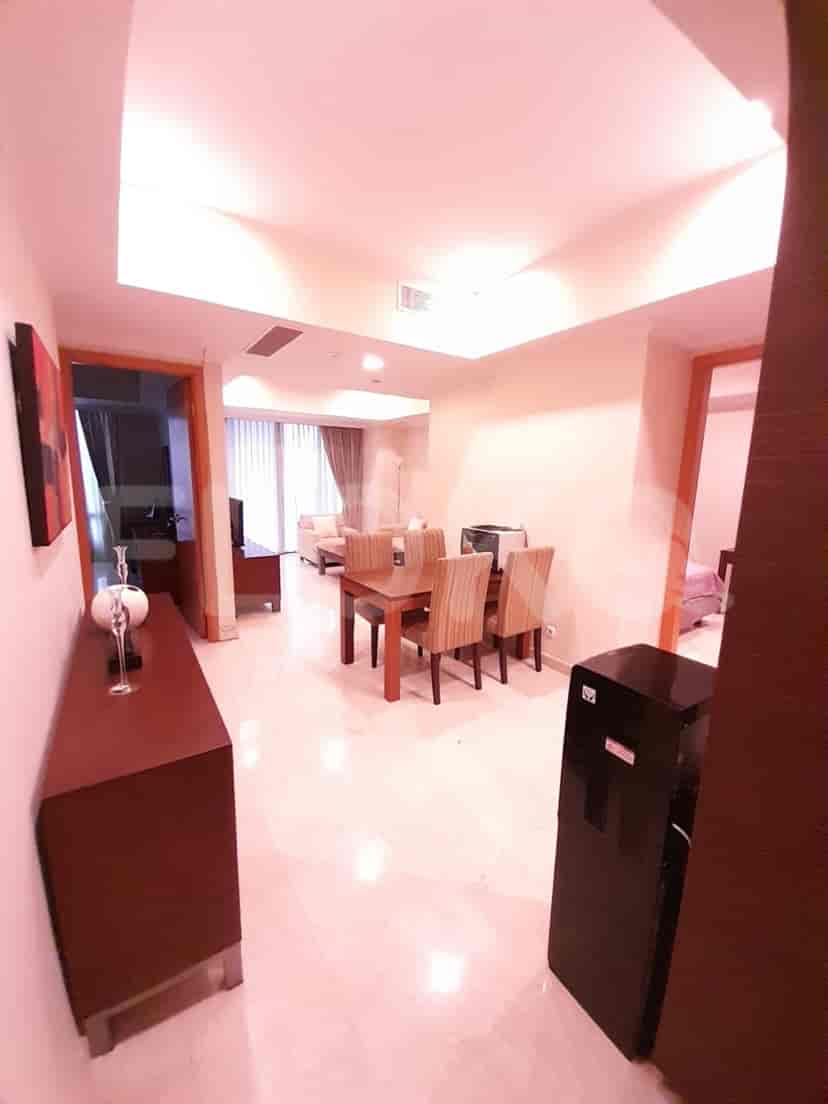 Living room with dining area, cabinet, and balcony access.