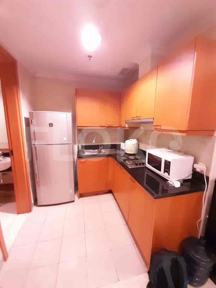 Small kitchen with cabinets, appliances, and a microwave.