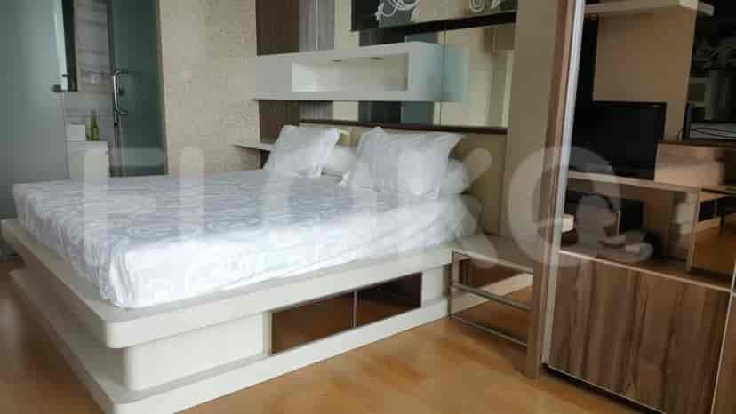 Bedroom with a bed, nightstand, and wall decor.