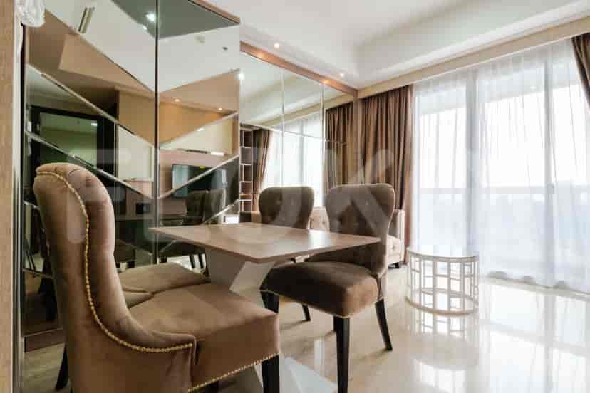Dining area with a dining table and chairs, adjacent to the living room.