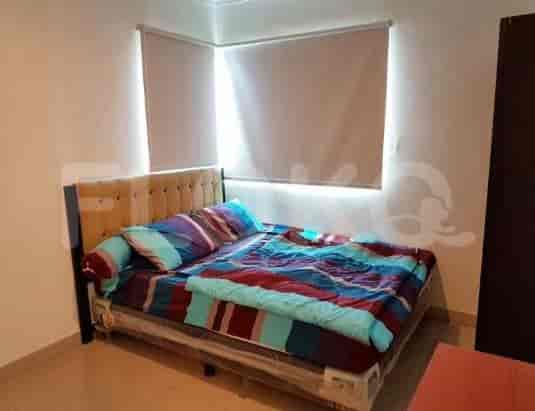 A bedroom featuring a bed, window, and simple decor.