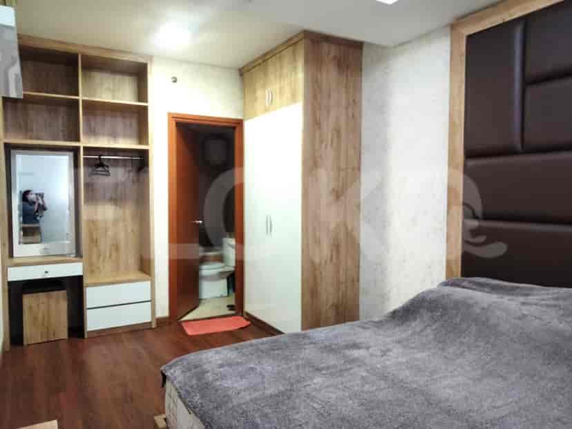 A bedroom with a wardrobe and bed.