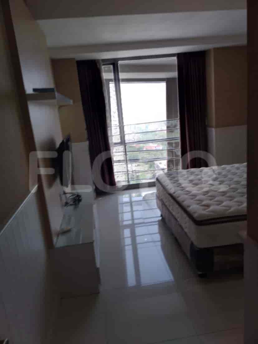 Bedroom with a bed, curtains, and window with a view.