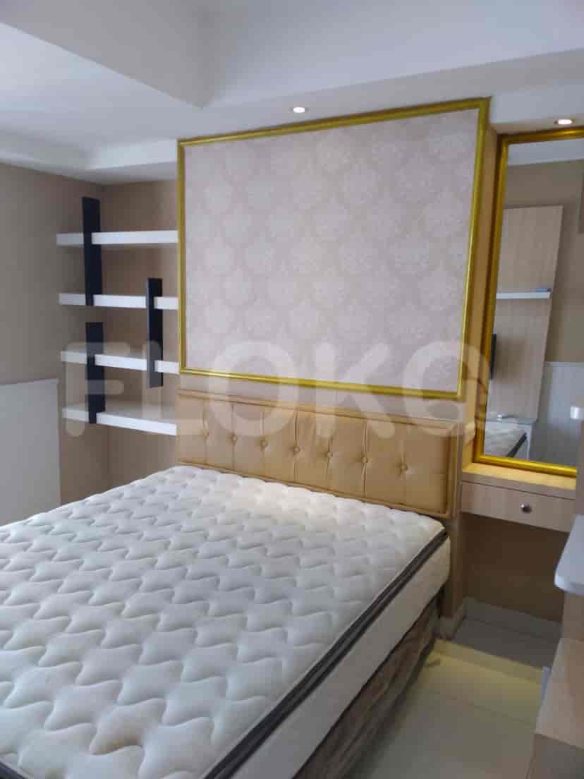 A modern bedroom with a double bed, mirror, and shelves.