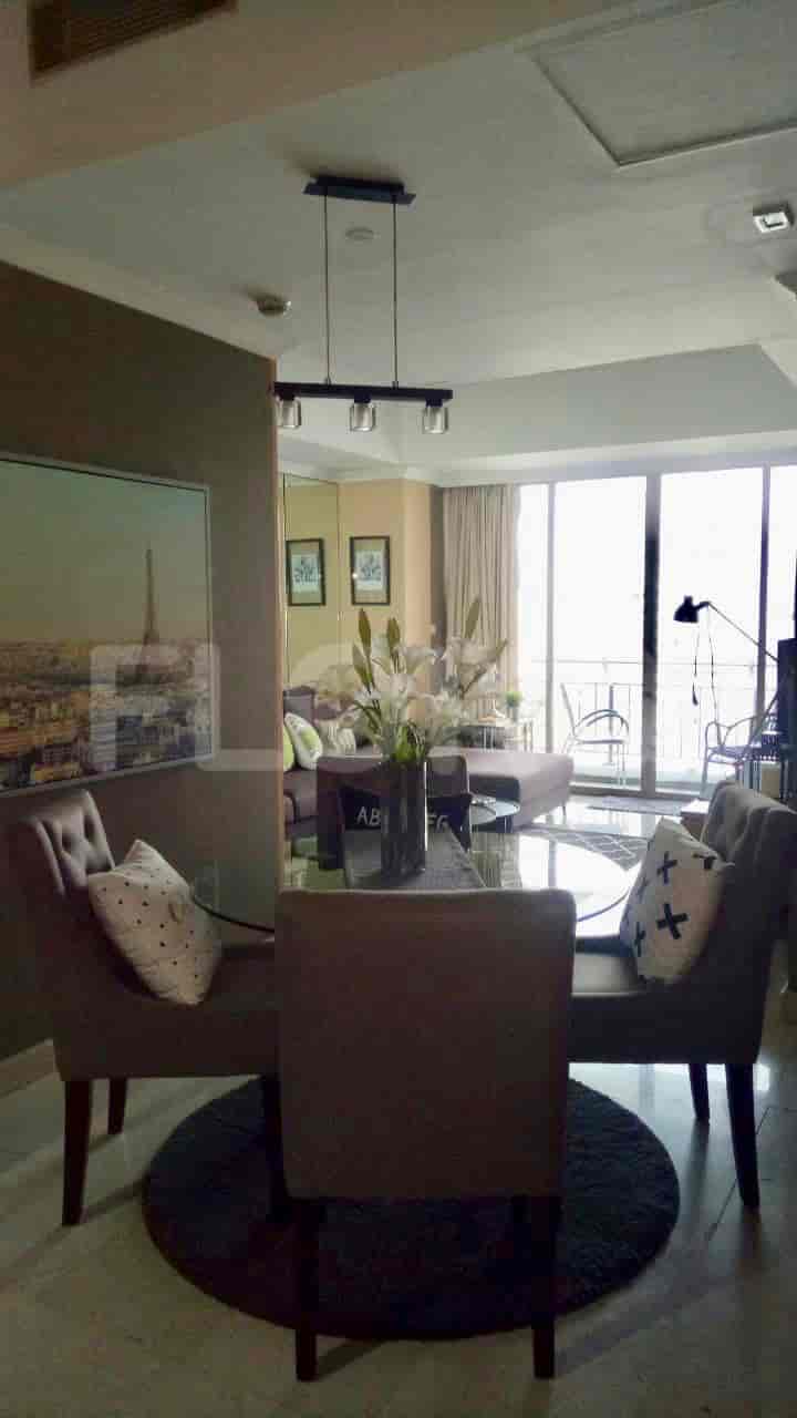 A dining area connected to a living space with a dining table and chairs.