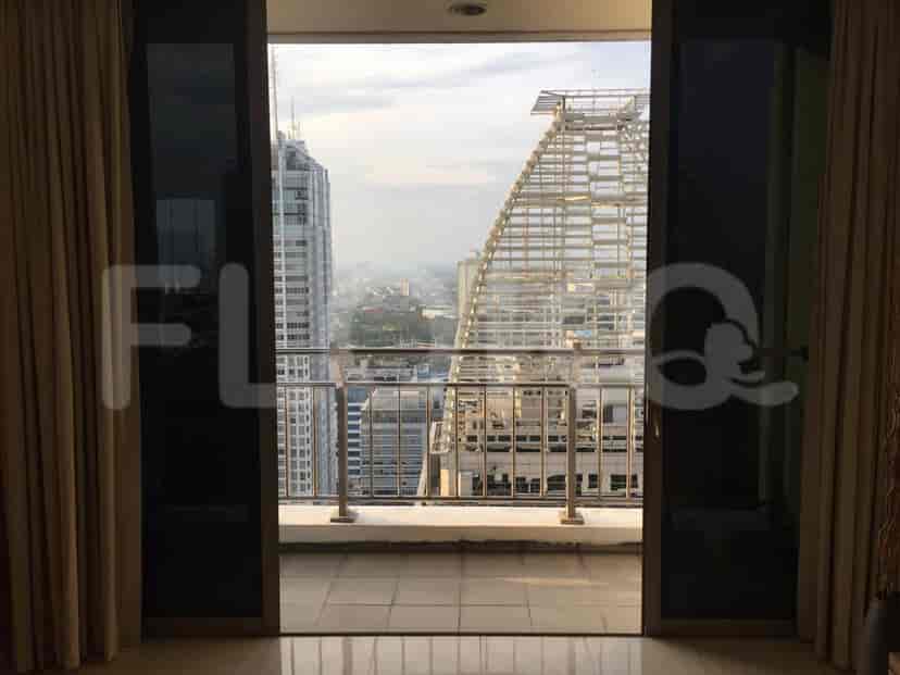 View of the city skyline through the open balcony doors.