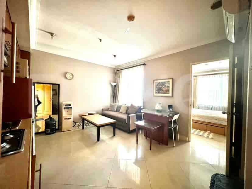 Living room with a sofa, dining table, and a desk.