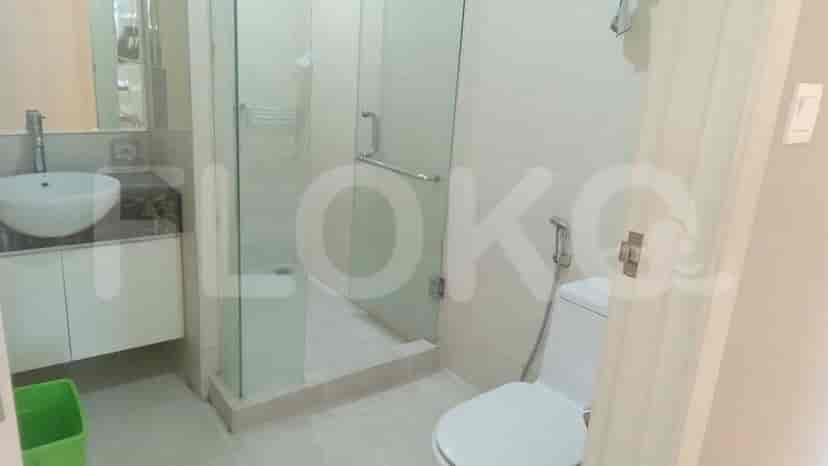 A modern bathroom with a glass-enclosed shower.