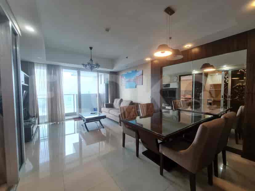 A spacious living and dining area with a large dining table and a view.