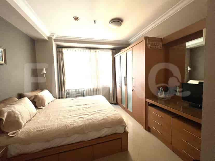 A bedroom with a bed, wardrobe, and a desk.