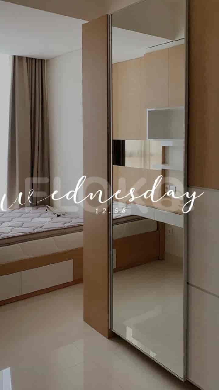 A bedroom with a bed and large mirror