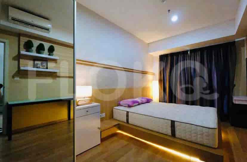 A bedroom with a bed, desk, and modern design.