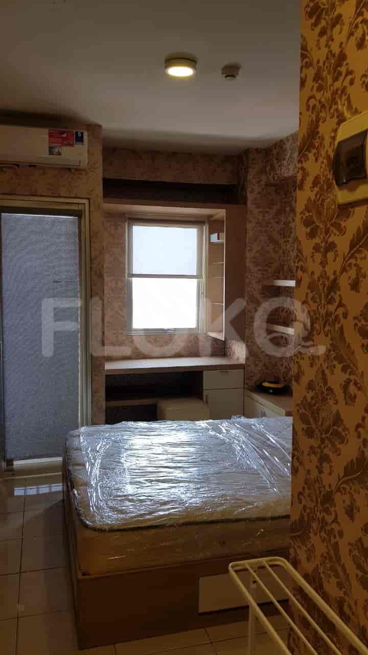 Bedroom with bed, window, and AC.