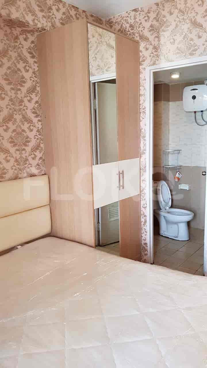 A bedroom and bathroom with wardrobe.