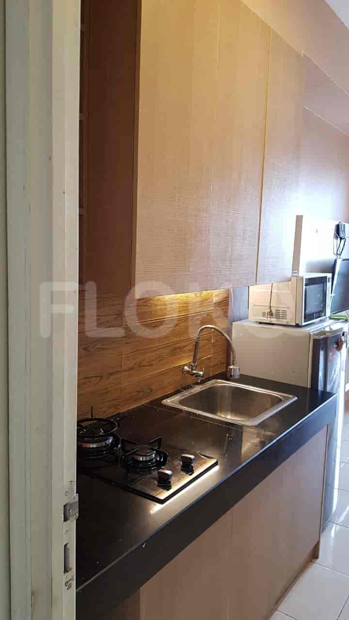 Kitchen with a sink, stove, and microwave.