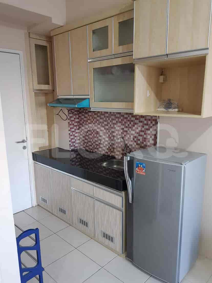 A kitchen with wooden cabinets.