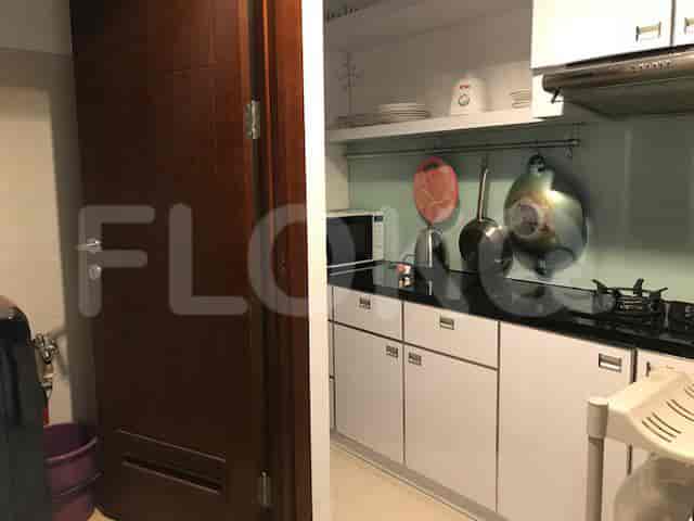 A well-organized kitchen with white cabinetry, a microwave, and a gas stove.