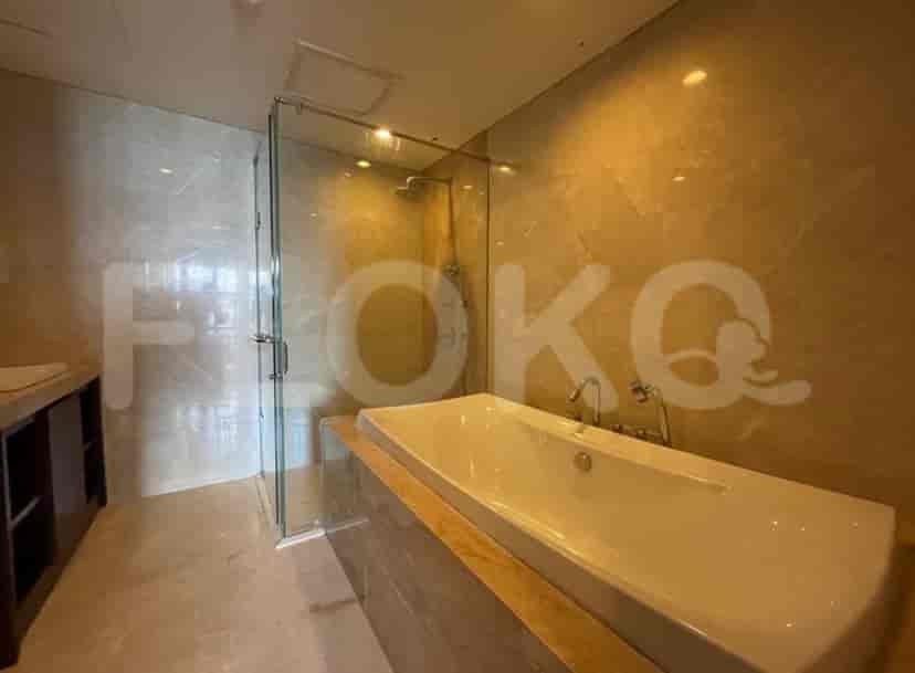 A luxurious bathroom with a soaking tub, a glass shower enclosure, and a marble finish.