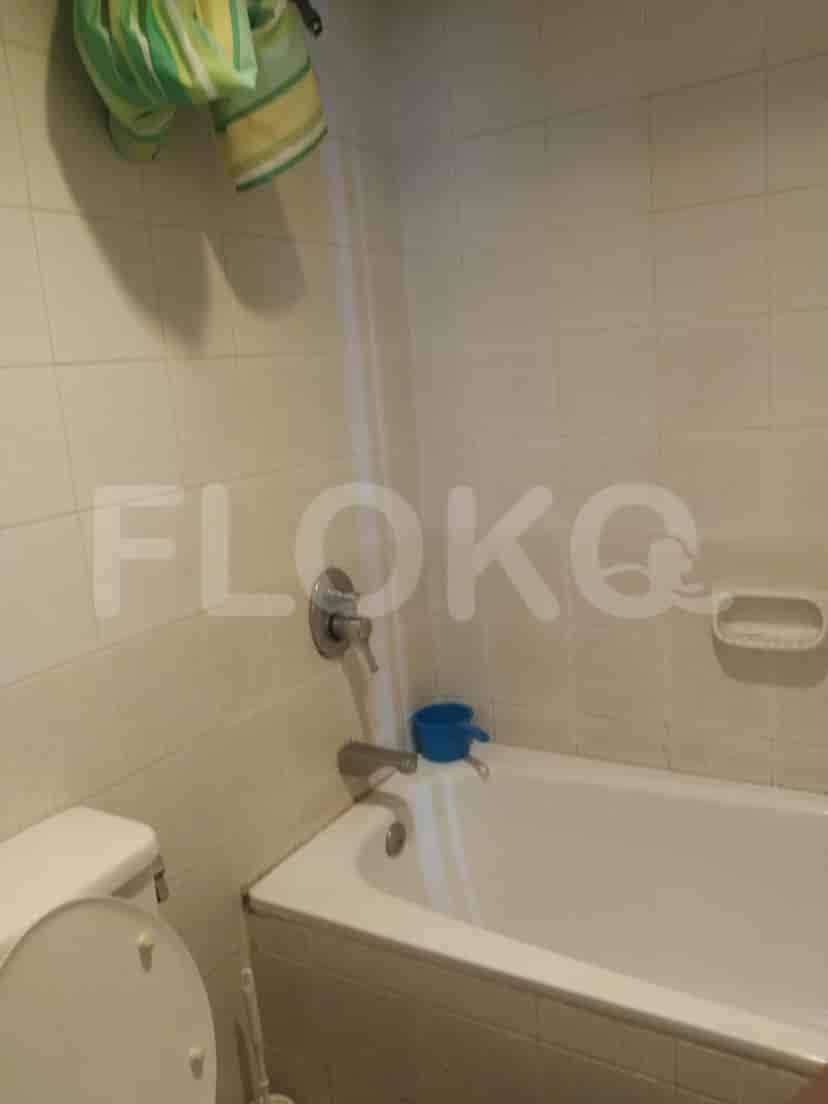 A well-lit bathroom with a bathtub and a toilet