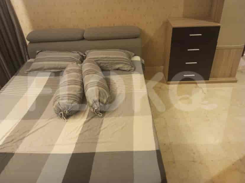 A cozy bedroom with a queen bed, bedside table, and patterned bedding.