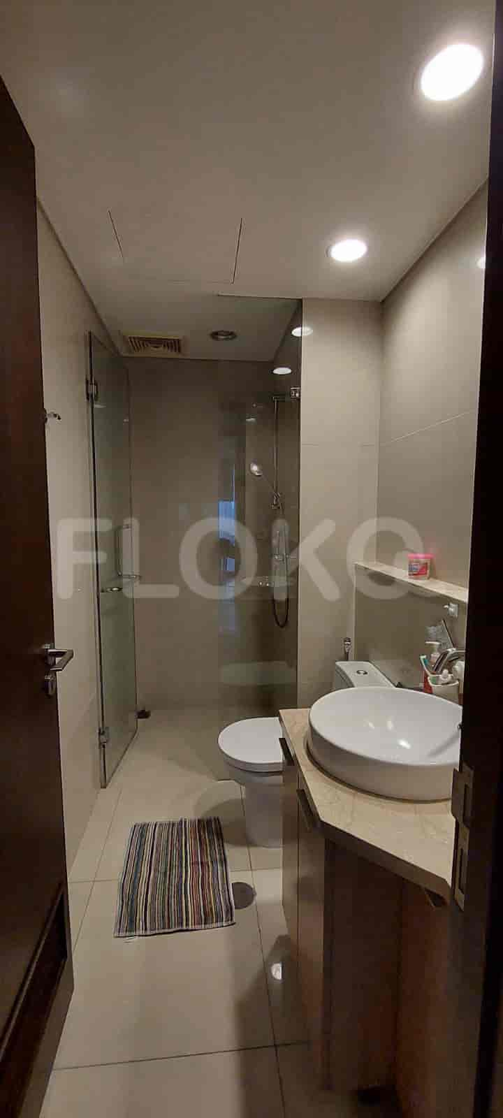 A modern bathroom with a glass shower and white fixtures.