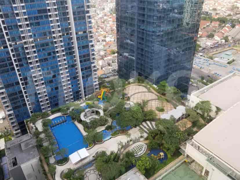 Aerial view of buildings, a swimming pool, and a playground.