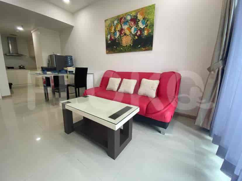 Dining area adjacent to the kitchen with a glass table and black chairs.