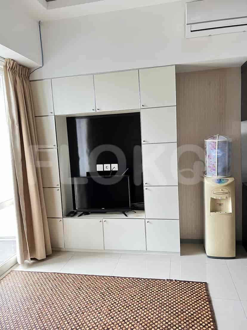 Living room with a wall-mounted TV unit and rug.