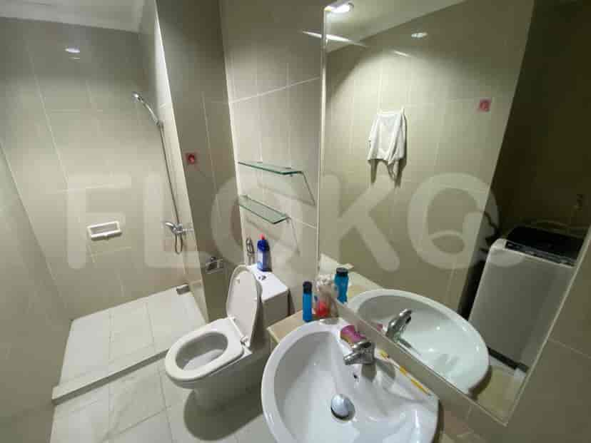 A clean bathroom with a toilet, sink, mirror and shower.