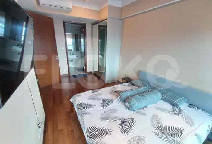 Pemandangan kamar tidur yang lebih luas, menampilkan tempat tidur, lemari, dan pintu masuk kamar mandi.