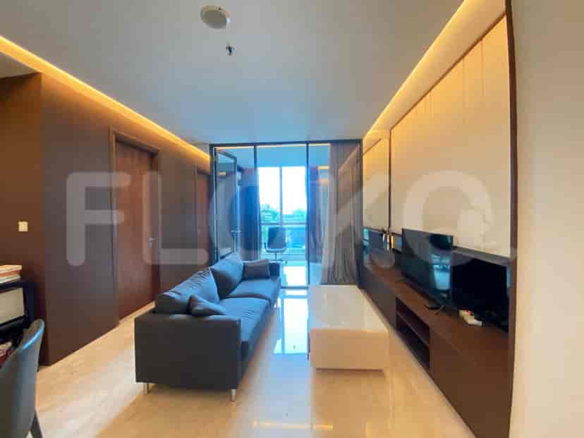 Modern living room featuring a grey sofa, built-in entertainment unit, and floor-to-ceiling windows.