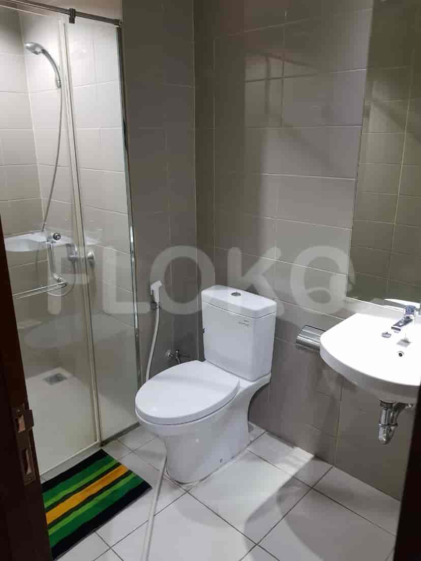 A bathroom with a toilet, sink, and shower.