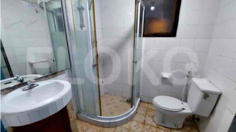 A bathroom with a shower, sink, and toilet.