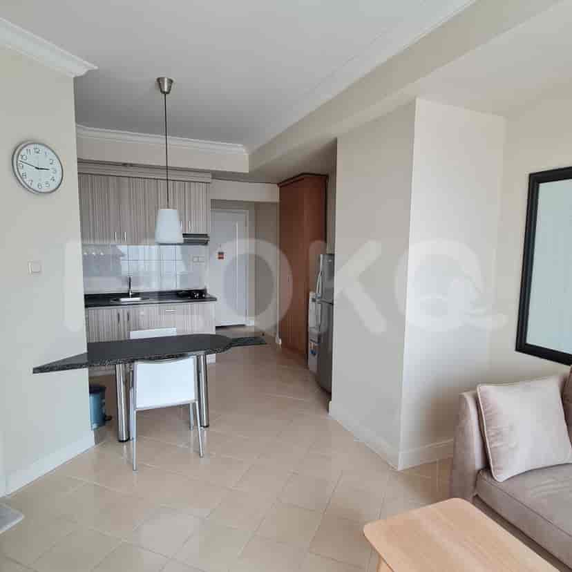 A living room with an open plan kitchen layout.