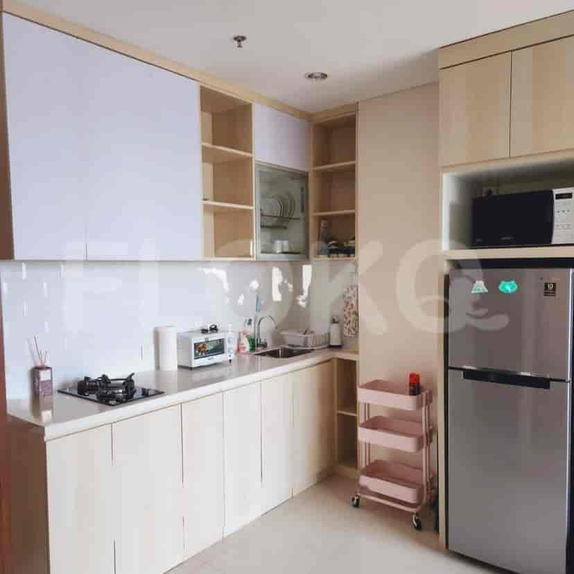 A kitchen area with wooden cabinets, white backsplash, and stainless steel appliances.
