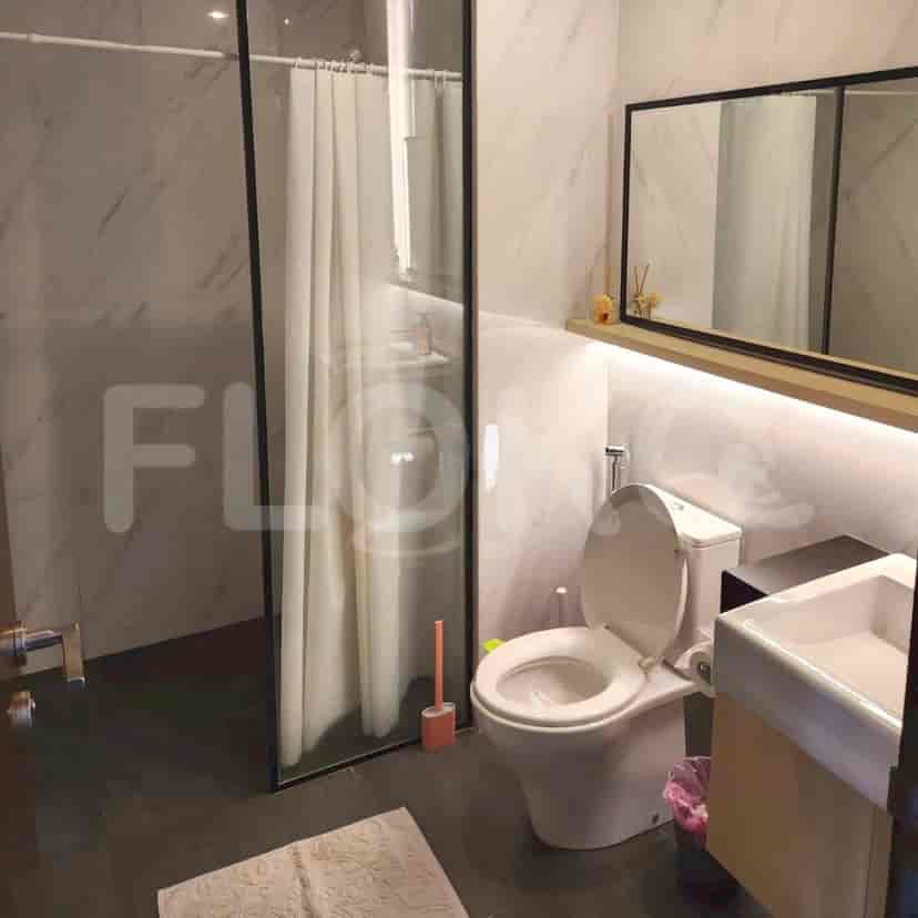 Bathroom with a shower, toilet, and sink.