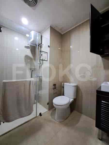 A modern bathroom with a shower and toilet.