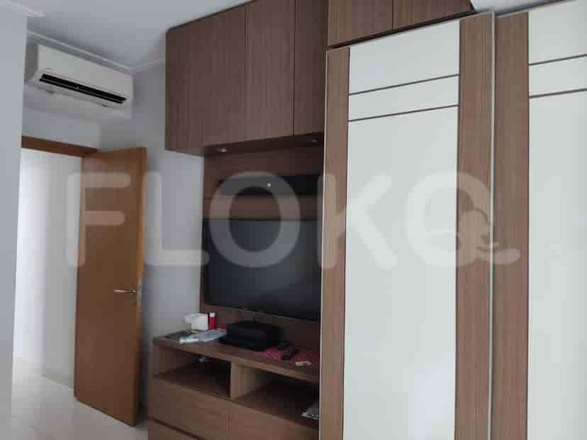 Bedroom with TV and wardrobe.