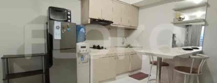 Kitchen with cabinets, refrigerator, and dining area.